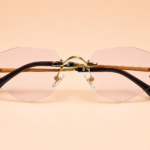 Rimless geometric sunglasses from NeXova UK with blush pink lenses and gold-tone frame details