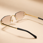 Rimless geometric sunglasses from NeXova UK with blush pink lenses and gold-tone frame details