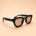 Black round unisex sunglasses with glossy black frame and warm brown tinted lenses