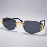 Rimless geometric sunglasses from NeXova UK with smoke grey lenses and gold-tone frame details
