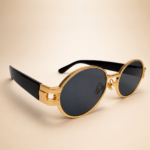 Front view of gold oval sunglasses with smoke black lenses and black side arms