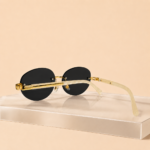 Rimless oval unisex sunglasses from NeXova UK with black lenses, gold-tone bridge and cream temples