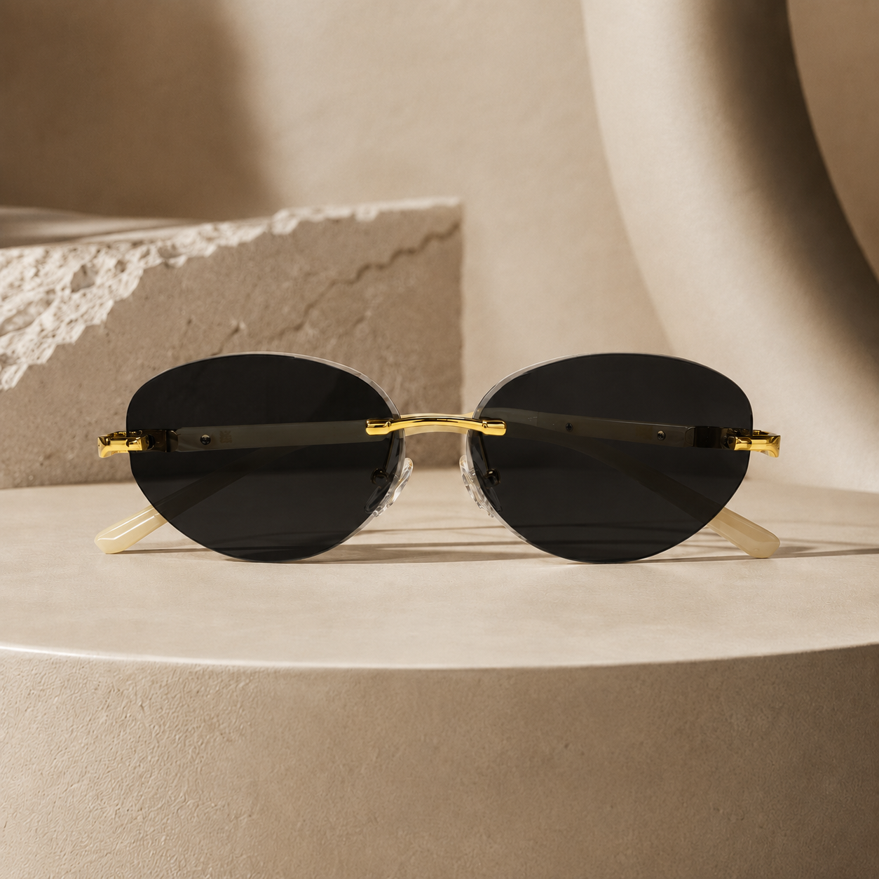 Rimless oval unisex sunglasses from NeXova UK with black lenses, gold-tone bridge and cream temples