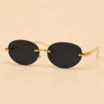 Rimless oval unisex sunglasses from NeXova UK with black lenses, gold-tone bridge and cream temples